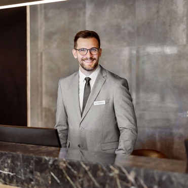 Smiling receptionist in grey suit