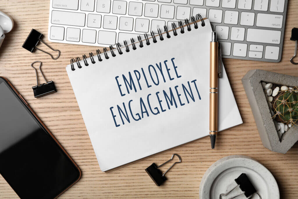 A page from a notebook with the word Employee Engagement on the desk