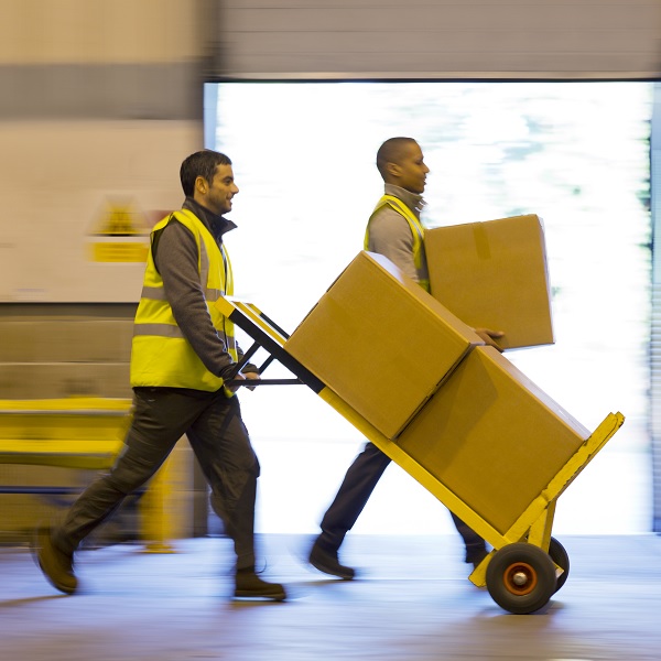 Workers with trolley full of boxes