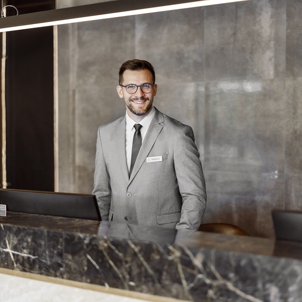 Smiling recptionist in grey suit