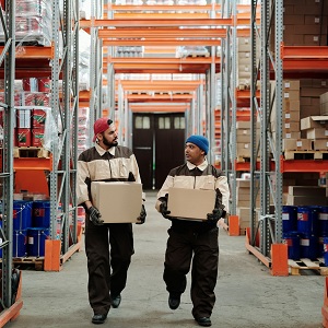 Warehouse workers carrying boxes