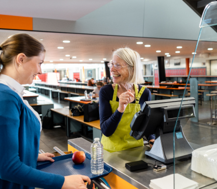 Smiling worker confirming order in POS system