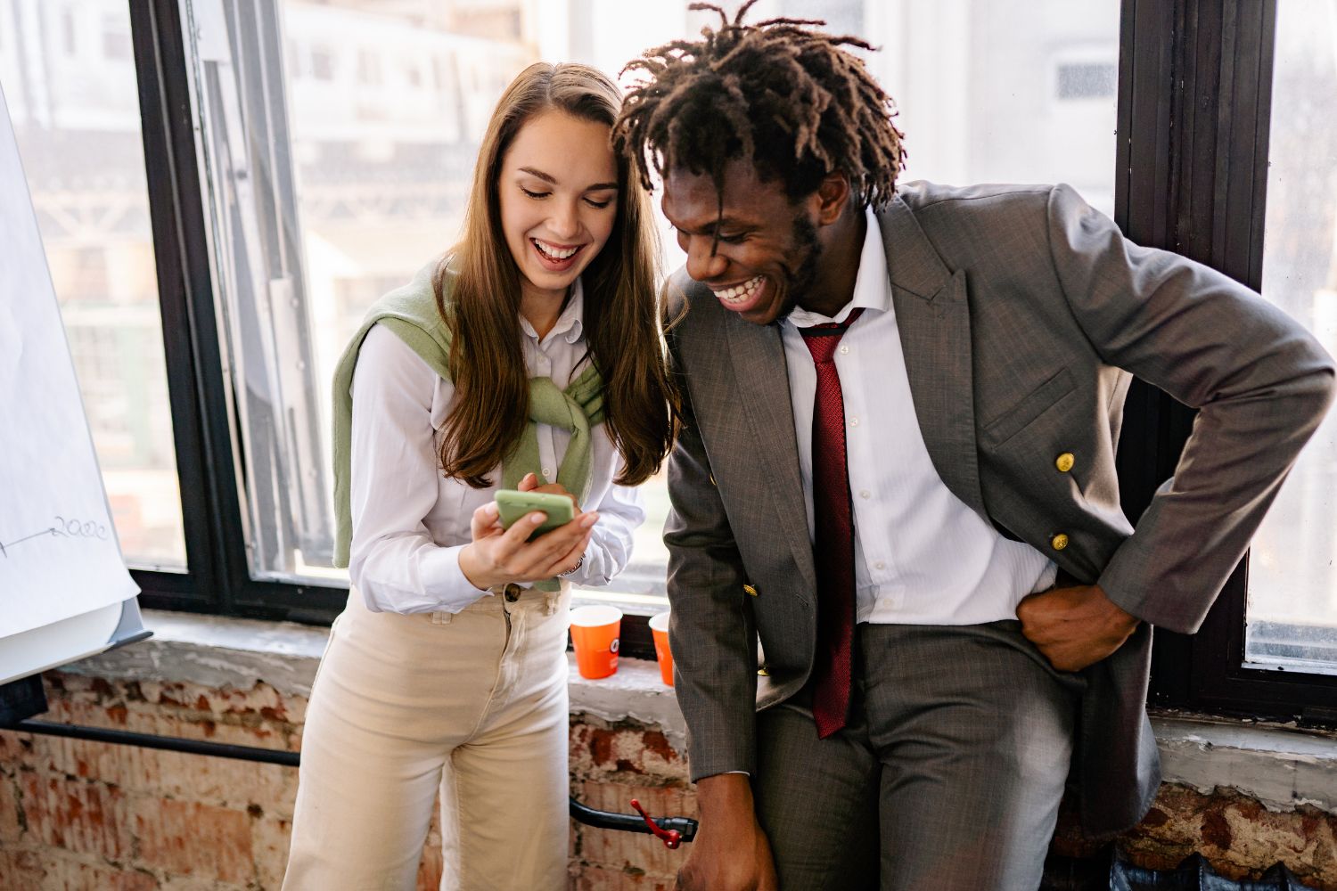 Two coworkers coordinating a shift swap on a mobile phone